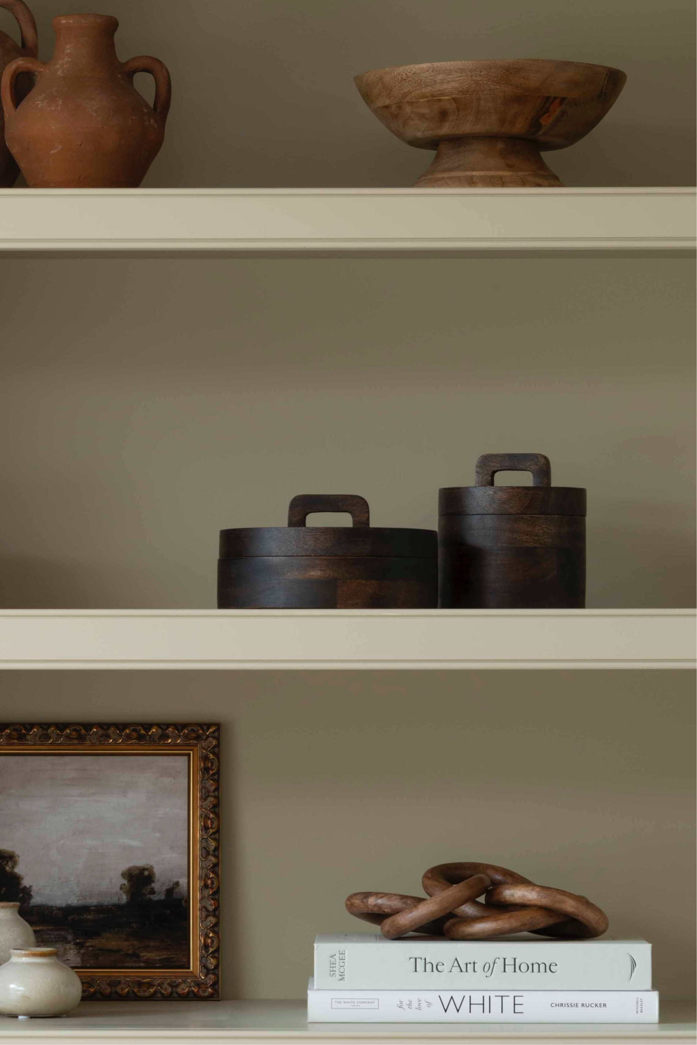 A striking wooden pot with lid in dark wood.