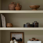 A striking wooden pot with lid in dark wood.