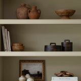 A striking wooden pot with lid in dark wood.