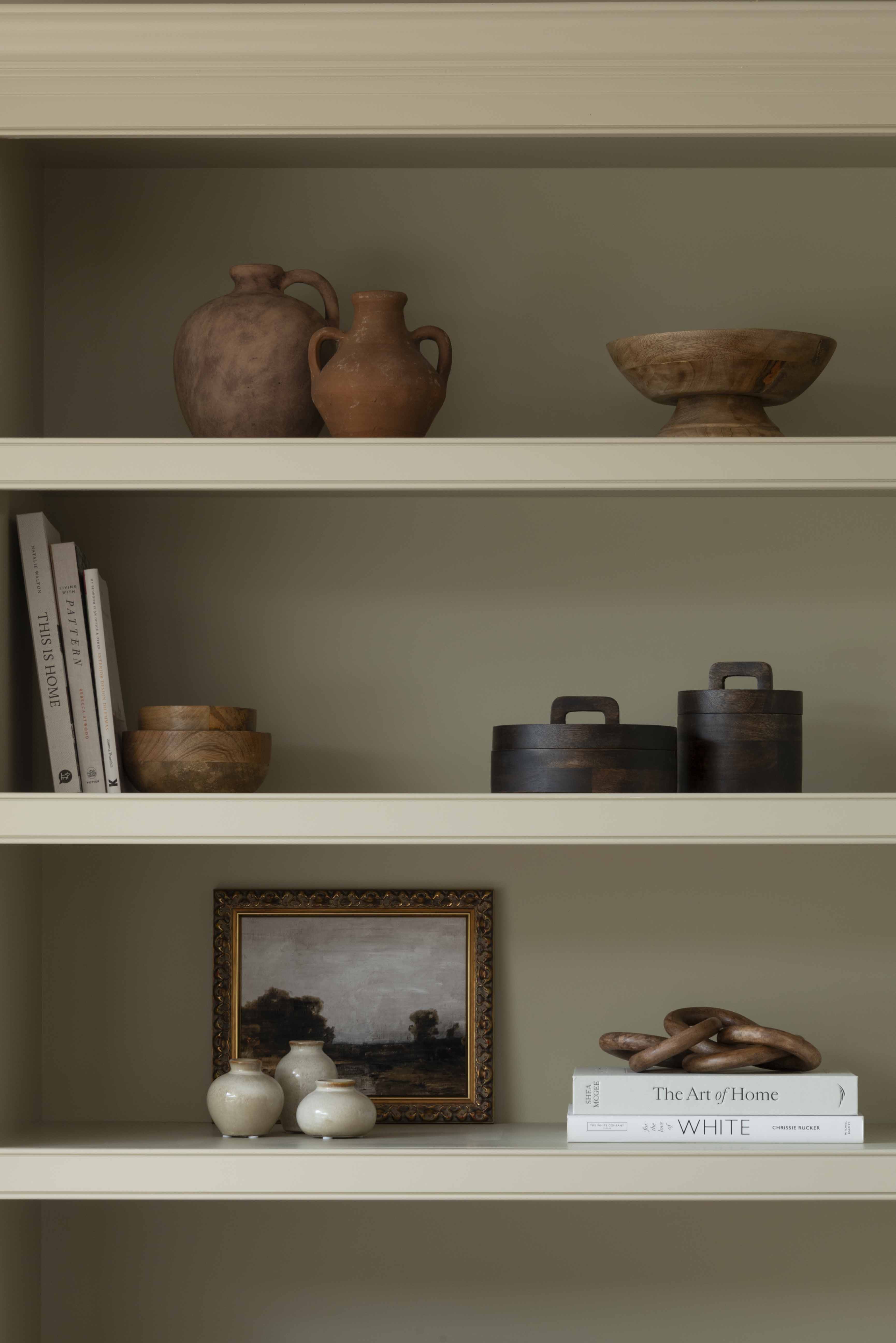 A striking wooden pot with lid in dark wood.