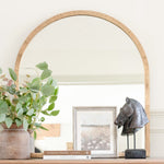 A stunningly crafted brass-framed arched top mirror.