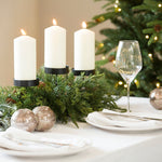 A gorgeous candleholder adorned with fir stems.