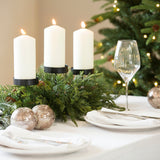 A gorgeous candleholder adorned with fir stems.