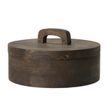 A striking wooden pot with lid in dark wood.