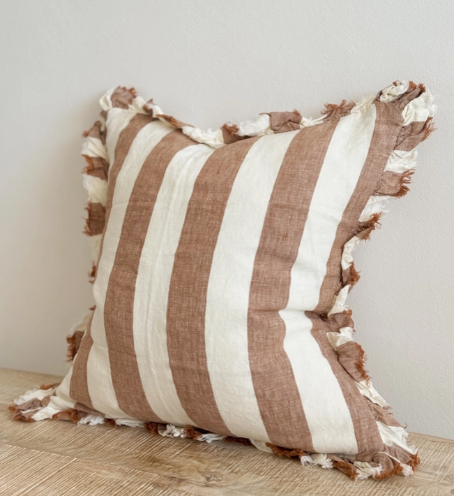 A beautiful linen cushion in a rich rust stripe pattern colour featuring ruffled edges.