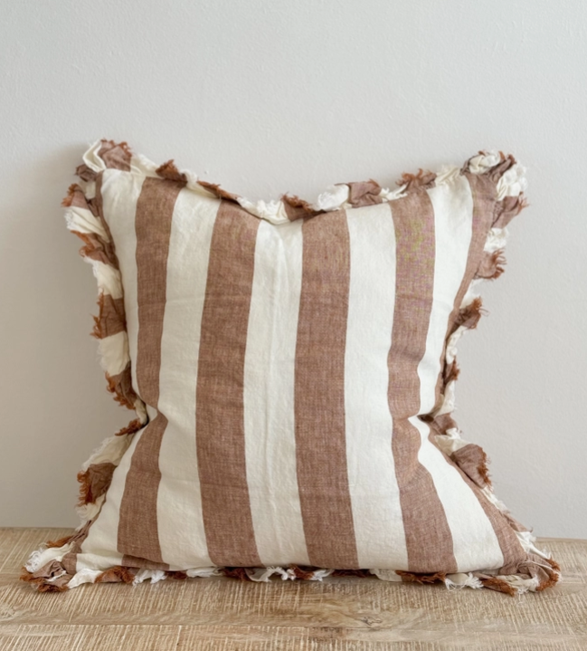 A beautiful linen cushion in a rich rust stripe pattern colour featuring ruffled edges.