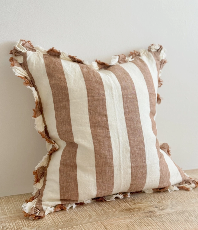 A beautiful linen cushion in a rich rust stripe pattern colour featuring ruffled edges.