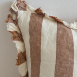 A beautiful linen cushion in a rich rust stripe pattern colour featuring ruffled edges.